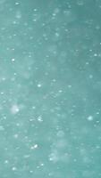 Blurred background of turquoise color and many particles blurred in the air. video
