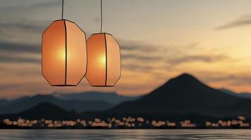 Orange Paper Lanterns at Sunset Over Mountains and Water photo