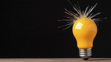 Illuminated Yellow Light Bulb with Glowing Filament on Dark Background Studio Shot photo