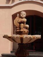 An elegant Artisan Fountain Sculpture that blends art with a water feature for outdoor spaces photo
