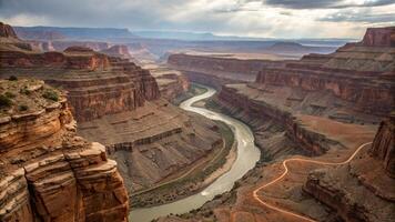 breathtaking canyon landscape featuring rugged cliffs and winding river. dramatic layers of rock create stunning visual contrast against sky, evoking sense of adventure and exploration photo