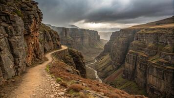 A deep and twisting canyon with rugged cliffs, showcasing dramatic landscapes and winding path along edge. scene evokes sense of adventure and awe in nature beauty photo
