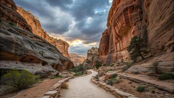 winding path through stunning canyon with towering sandstone walls, surrounded by dramatic clouds and natural beauty. scene evokes sense of adventure and tranquility photo