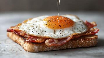 Crispy bacon, fried egg, and toast breakfast photo