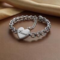 a silver heart bracelet with the word love engraved on it photo