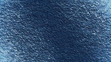 This deep blue textured surface offers a rich background ideal for eco-themed mockups, providing ample empty space for creative text placement and design elements. photo