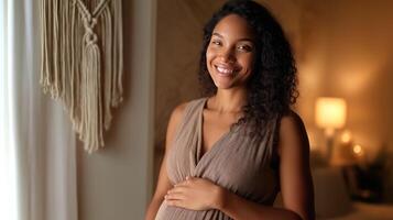 A pregnant Latina woman stands in a warmly lit living room, gently holding her belly while smiling. The atmosphere radiates warmth and anticipation. photo