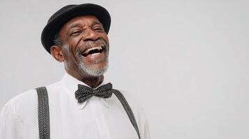A smiling black man wearing a hat and suspenders photo