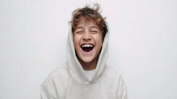 A boy in a hoodie laughing photo