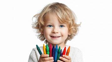 A young child holding a bunch of crayons photo