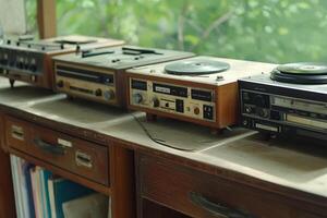 An old record player sitting on top of a wooden table photo