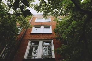 A building with many windows and trees photo