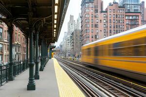 A train is moving down a track in front of a building photo