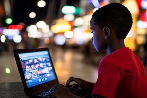A young boy is using a laptop computer photo