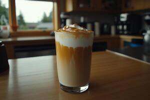 A drink with whipped cream and a coffee cup on a table photo