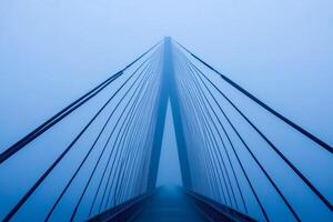 A bridge in the fog with a blue sky photo