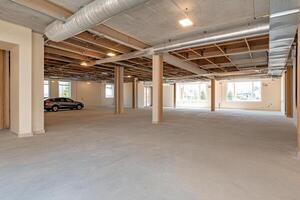 An empty room with a car parked in the middle photo
