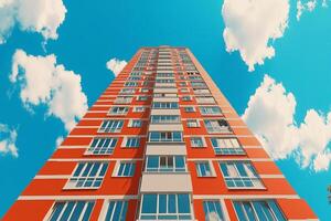A tall building with windows and a blue sky photo