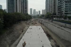 A large concrete area with construction workers on it photo