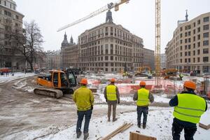 Construction workers in winter in front of a building photo