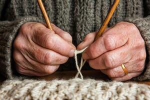A person knitting with two knitting needles photo