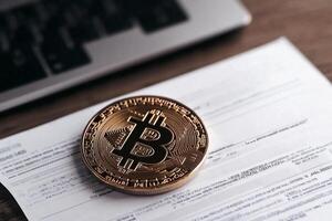 Bitcoin on a paper with a laptop photo