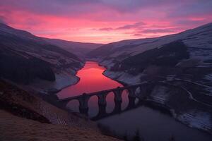 A bridge over a river with a red sky photo