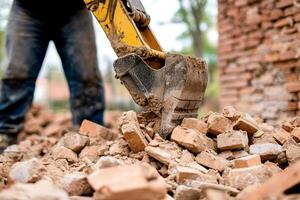 A man is using an excavator to dig up bricks photo