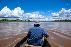 A man in a boat on a river with clouds in the background photo