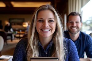 A man and woman smiling while sitting at a table photo