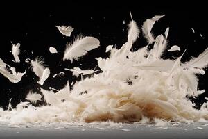 A pile of white feathers on a table photo