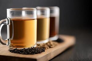 Three cups of tea sit on a wooden tray photo