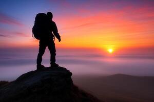 A person standing on top of a mountain with a backpack photo