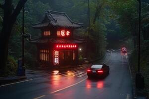 A car driving down a wet road with a chinese pagoda in the background photo