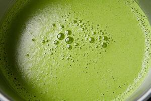 A close up of a green liquid in a pot photo