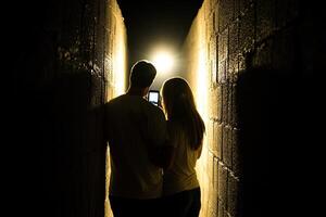 A couple standing in a dark tunnel photo