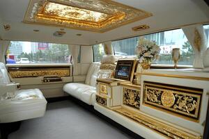 The interior of a limousine with gold and white trim photo