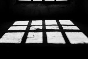 A black and white photo of a window with light coming through
