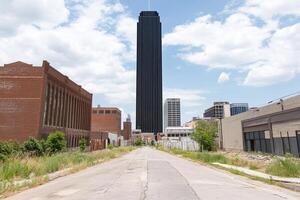 A paved road with a tall building in the background photo