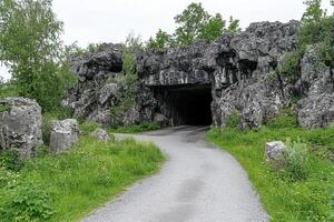 A tunnel in the middle of a rocky area photo