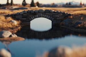 A stone bridge over a small pond in a field photo