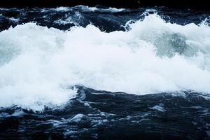 A person surfing on a wave in the ocean photo