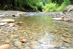 A stream of water running through a rocky area photo