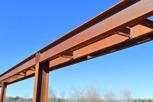 A large steel beam with a blue sky in the background photo