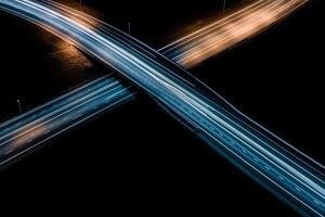 An aerial view of two highway overpasses at night photo