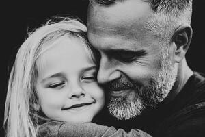 A man and a little girl hugging in black and white photo