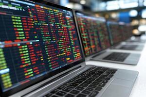 Laptops with stock market data on them photo