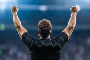 A man with his arms raised in the air photo