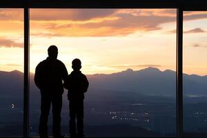 A man and a boy standing in front of a window photo