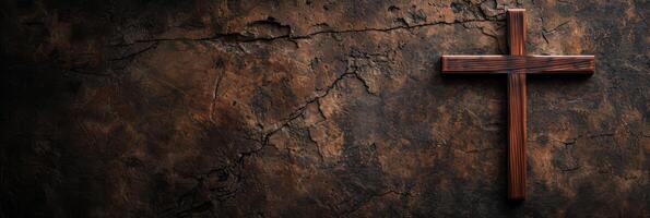 Wooden cross on cracked earth background. photo